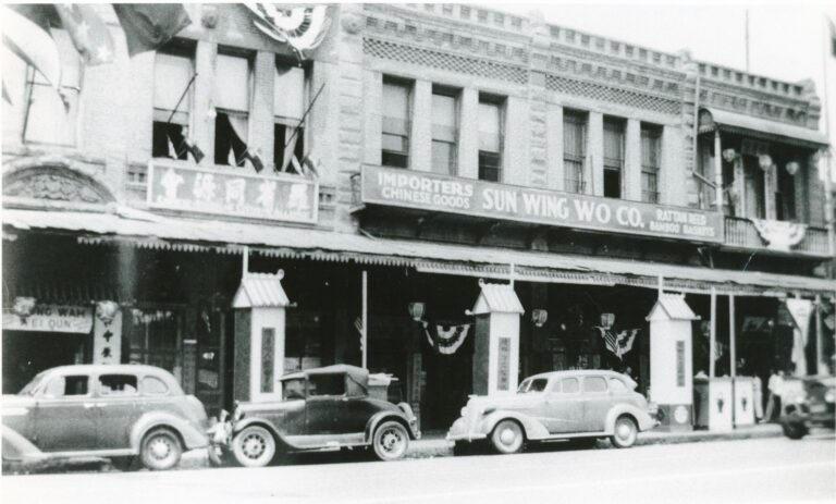 Black and white photo of Chung Wah (Chinese Consolidated Benevolent Association) and Sun Wing Wo Co. general store in the Garnier Building in Old Chinatown