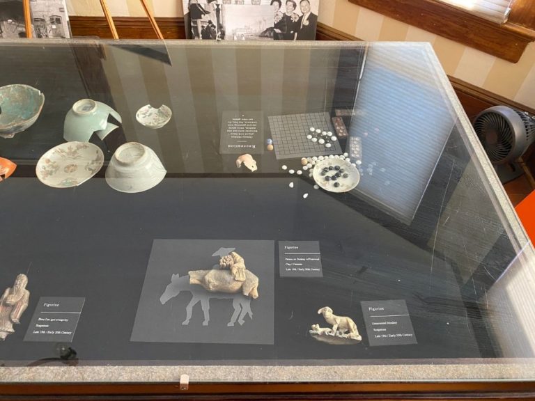 Photo of front display room showing detailed view of the artifacts in the display case with more figurines