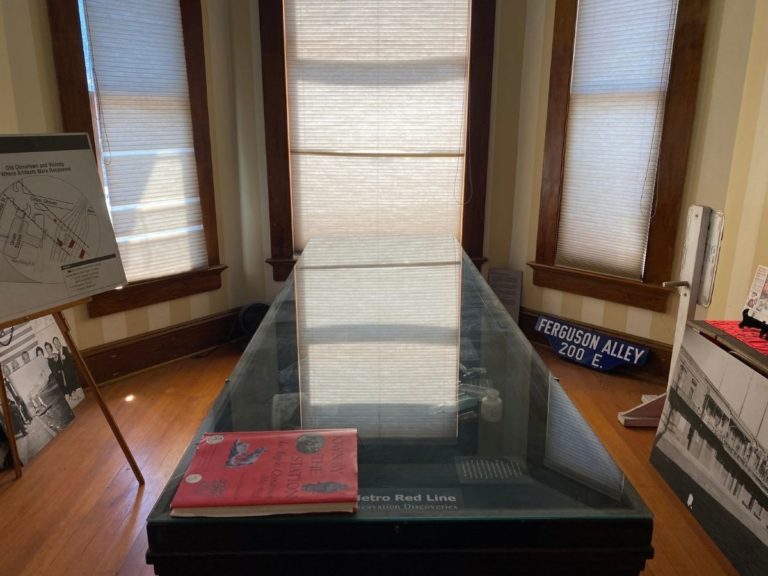 Photo of front display room facing the bay windows with artifact display case