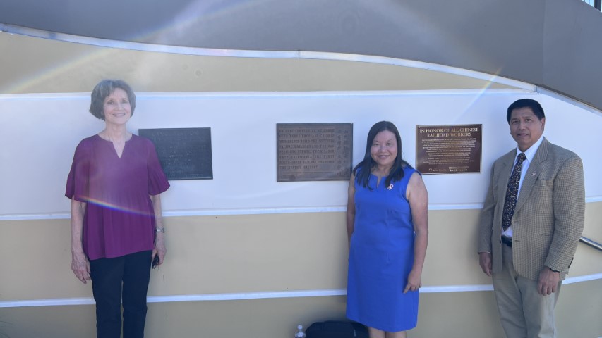Susan Dickson, Grace Leo and Ricky Leo standing next to the plaques at Vista Canyon Metrolink Station