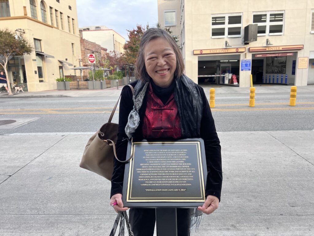 Susie LIng standing behind plaque on Fair Oaks Ave.
