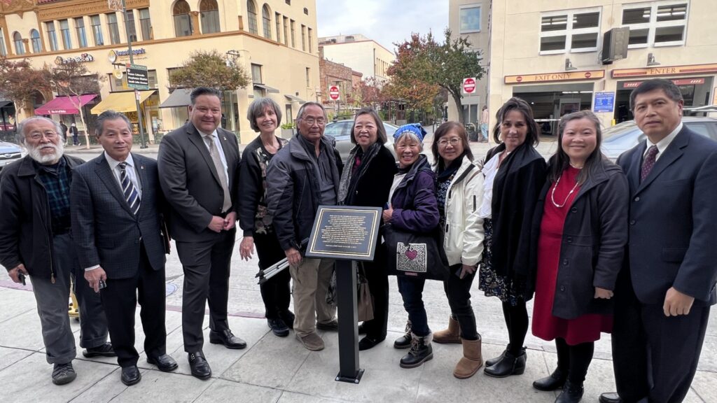 Group photo by plaque on Fair Oaks Ave.