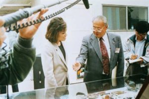 Photo of Irvin Lai talking to a reporter about the MTA Artifacts