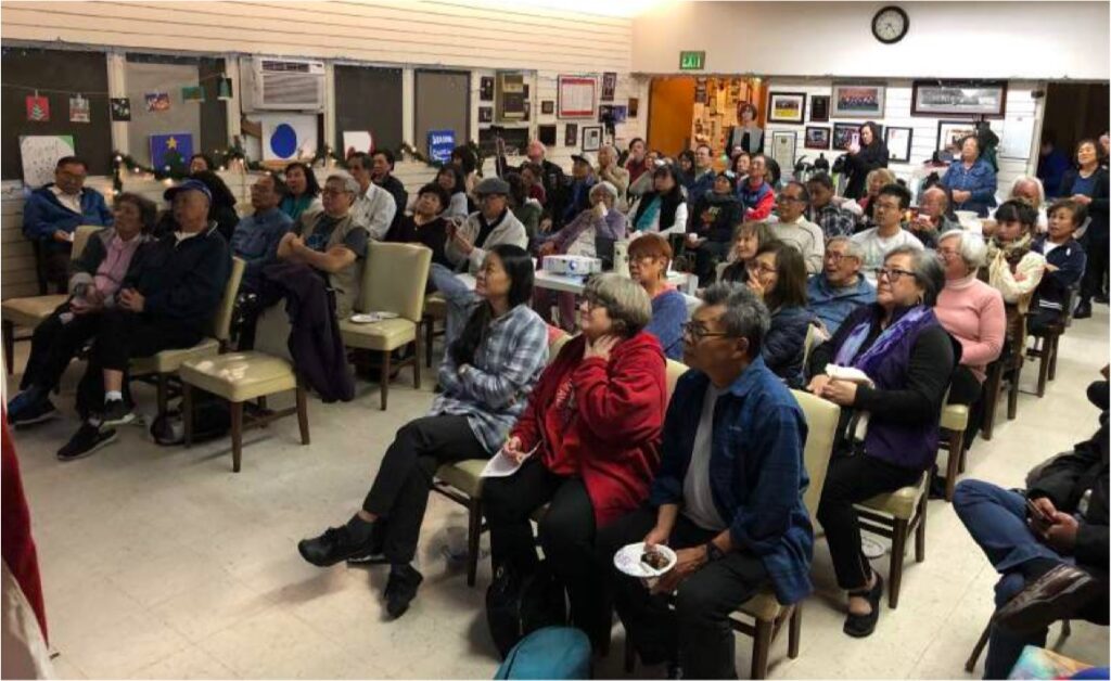 Photo of attendees at a monthly meeting